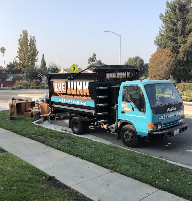 Bye Junk truck performing a junk removal in Newark, CA service